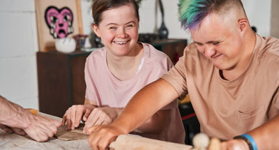 Young adults with downs syndrome baking
