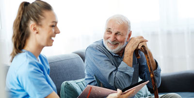 A carer talking to an elderly gentleman