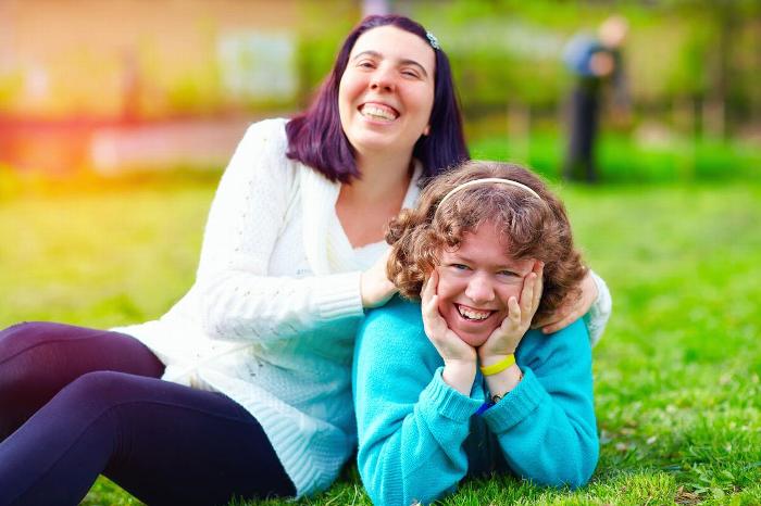 Young adults with learning difficulties sitting in a garden