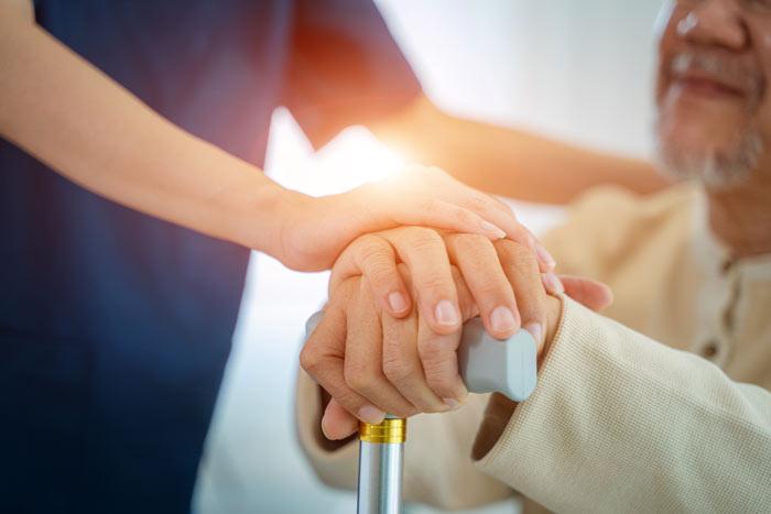 A carer helping an elderly patient